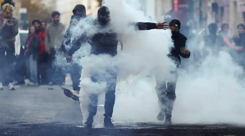 Demonstrators react amid tear gas, the day after a national day of demonstrations against the cost of living and rising fuel prices, in Paris, France, October 18, 2026. REUTERS/Abdul Saboor